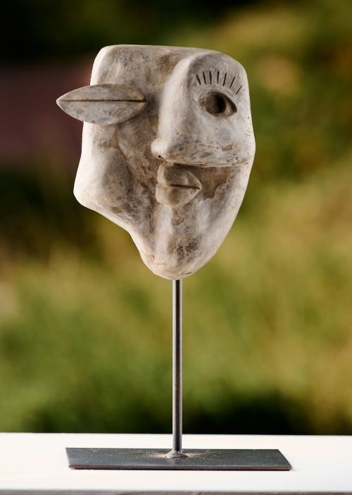 Winking man sculpture by Juan Carlos Marino Rosales